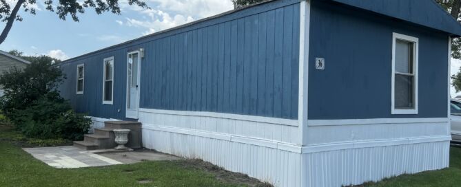 Blue wood siding with white skirting